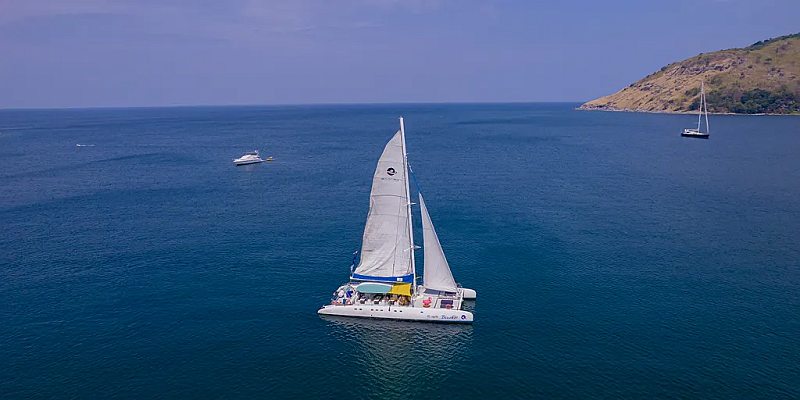 Blueket 75 FT open-air party catamaran cruising the Andaman Sea near Phuket